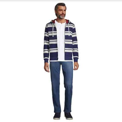 Lands End medium blue jeans on man wearing a striped zip up hoodie